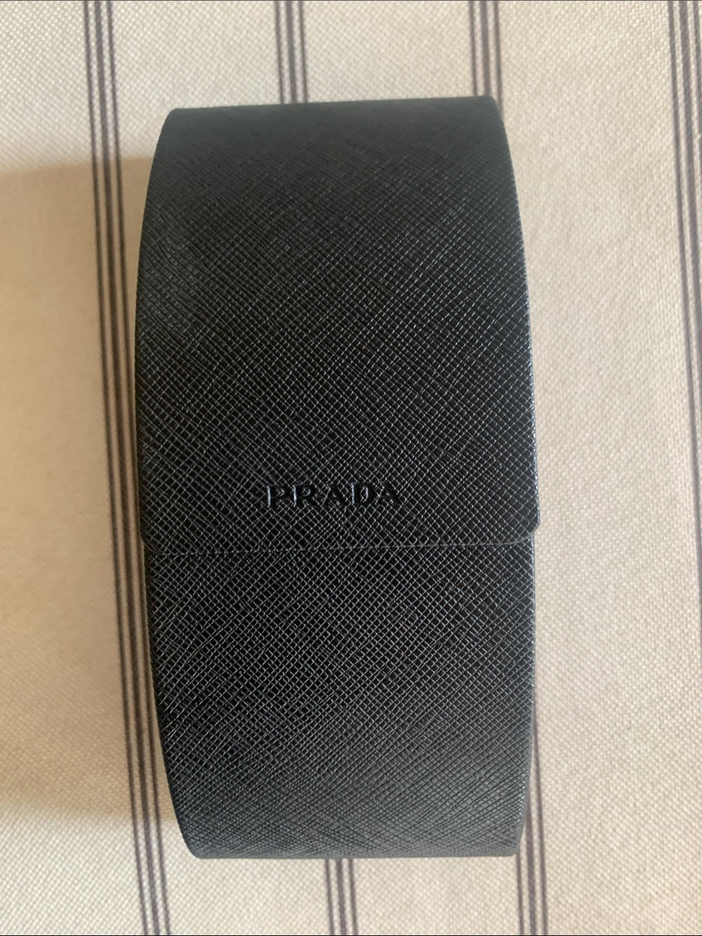 Prada Black Textured Hard Case with flip top and magnetic closure.